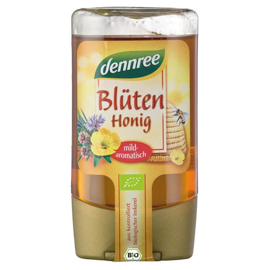 Bio Blütenhonig von DENNREE in 250 g Glas, cremige Konsistenz, mit frisch blühendem Honig in einem transparenten Glas.